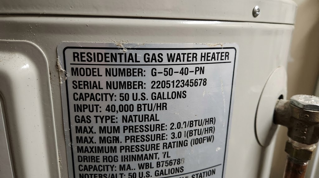 A close-up of a water heater rating plate on the side of the tank, showing the model, serial, and capacity